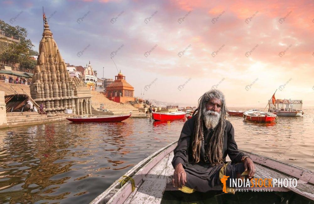 Indian Sadhu enjoy boat ride at Varanasi Ganges at sunset