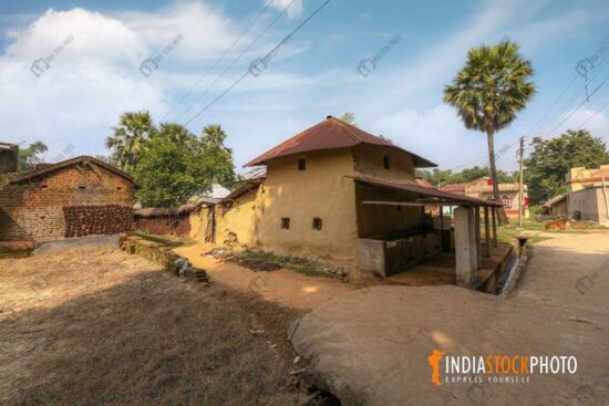 Indian village scene with mud huts and unpaved village road