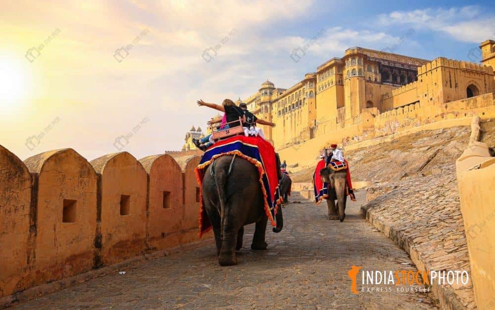 Tourist on elephant ride at Amber Fort Jaipur at sunrise