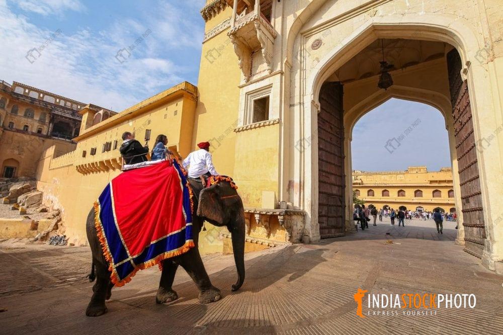Tourist on elephant back at the entrance of Amber Fort at Jaipur