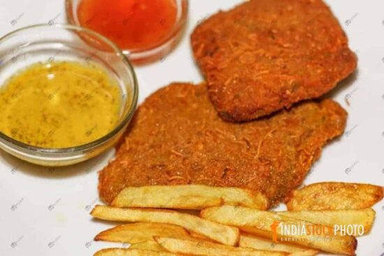 Tasty fish fry served with french fries and mustard sauce