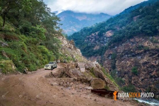 Tourist vehicle on dangerous mountain road at North Sikkim