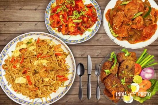 Chinese cuisine of mixed Hakka noodles with spicy chicken side dish