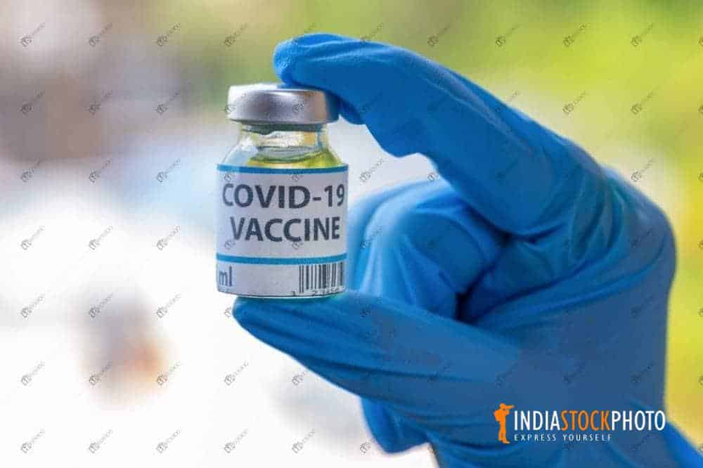 Doctor hand holding a coronavirus vaccine bottle