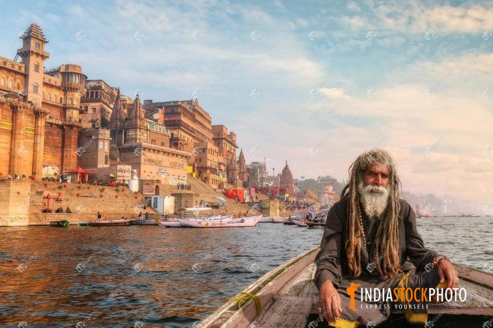 Hindu Sadhu baba on a boat on river Ganges at Varanasi at sunset