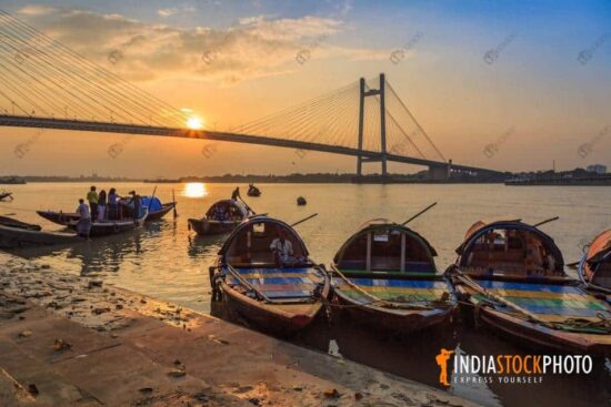 Wooden boats with Vidyasagar Setu on river Ganges at Kolkata