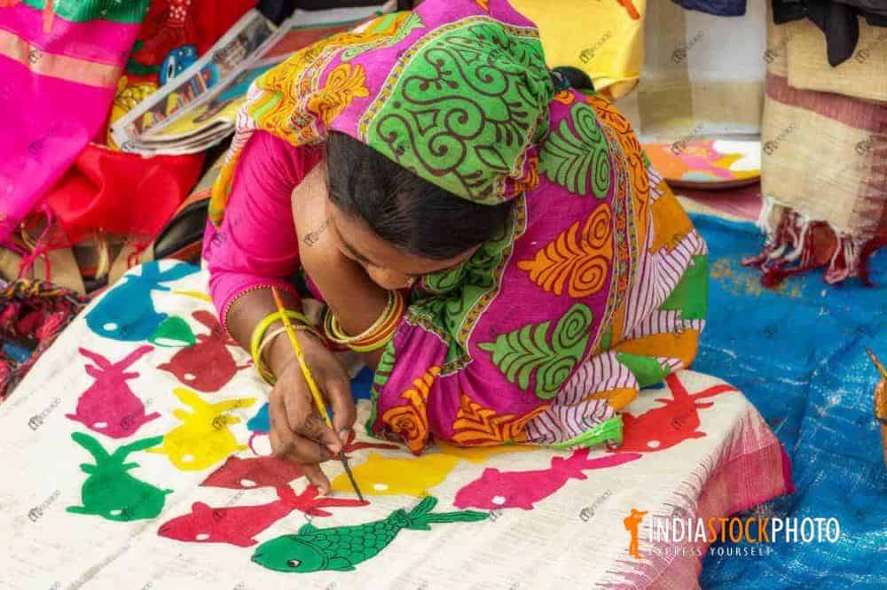 Rural woman artist fabric painting on women dress materials