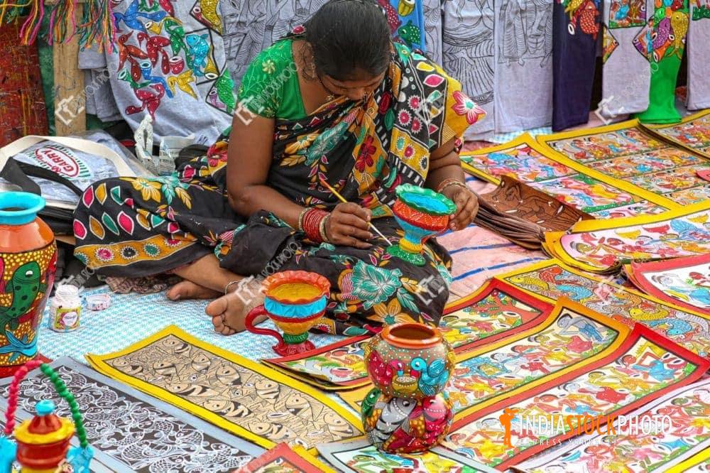 Indian woman artist fabric painting on handmade home decorative item