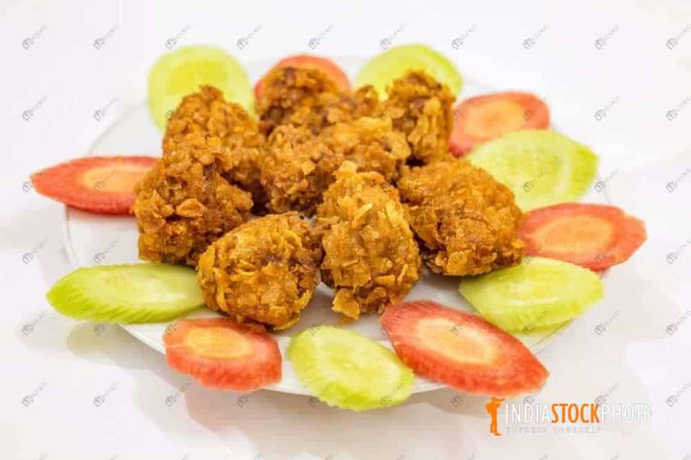 Spicy crispy Chicken pakora snacks served with salad