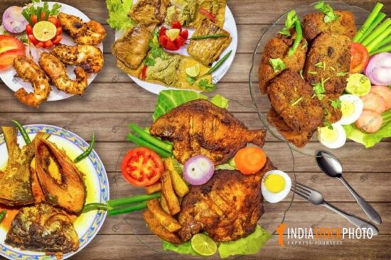 Tasty Indian fish cuisines served on a table garnished with vegetables