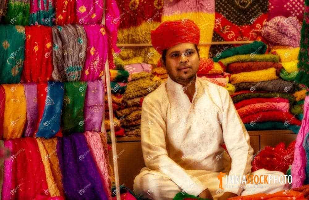 Rajasthani trader selling dress materials at garment shop at Jodhpur