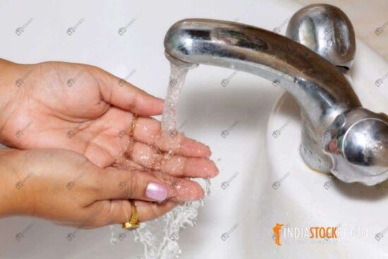 Woman washing hands for hygiene as Covid 19 awareness concept
