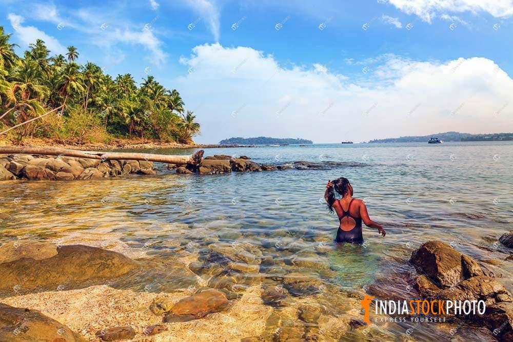 Female tourist swimming at North Bay island beach Andaman
