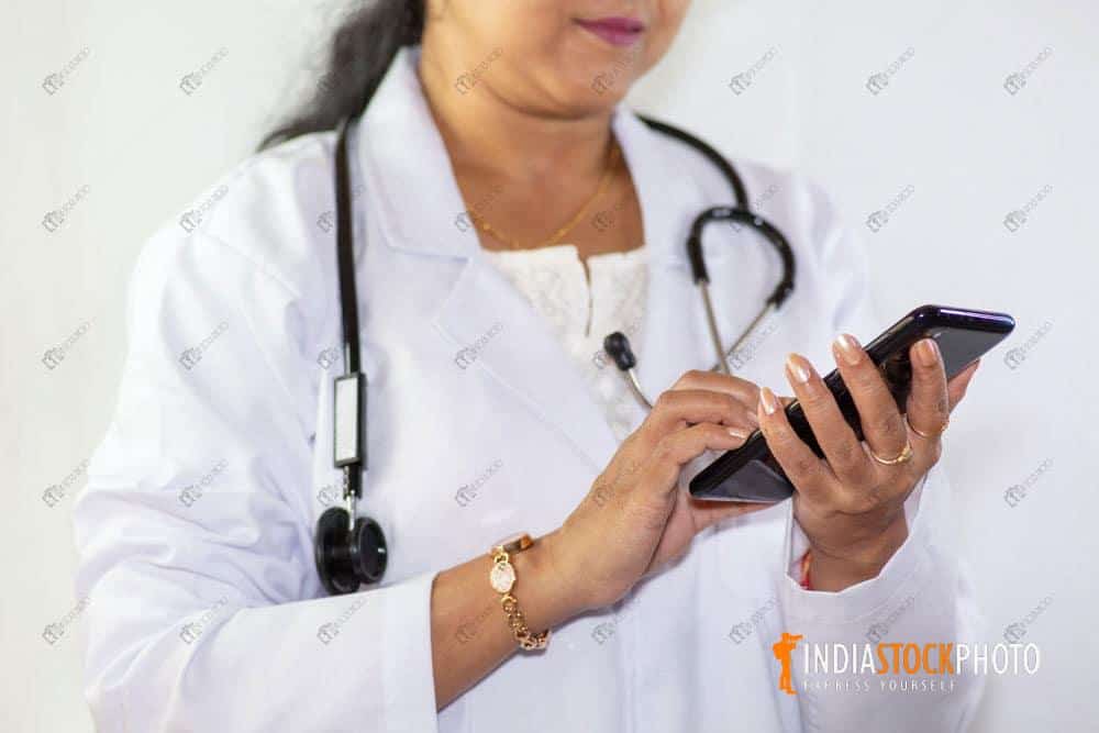 Indian lady doctor checks her mobile phone
