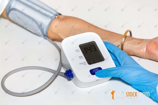 Nurse measure blood pressure of patient