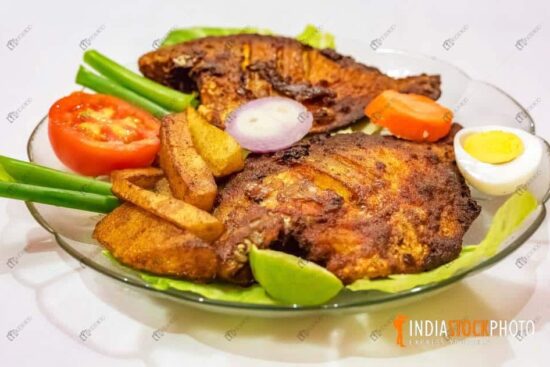 Spicy grilled Pomfret fish cuisine served with vegetables
