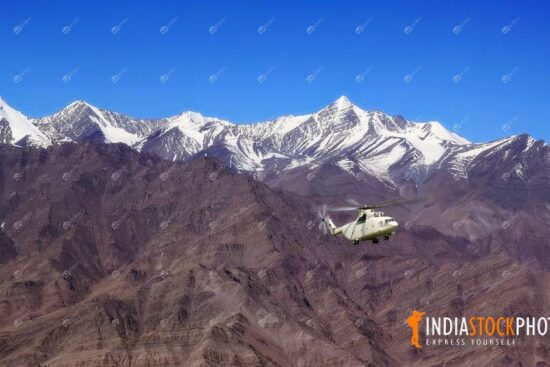 Helicopter flies over the Himalaya range at Ladakh India
