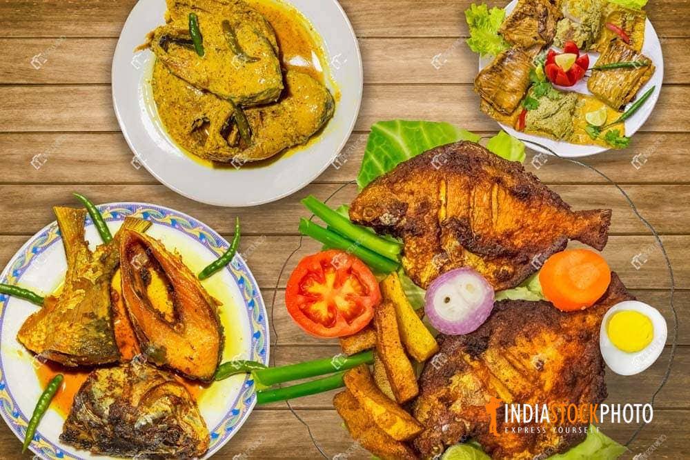 Indian fish cuisine dishes displayed on a wooden table