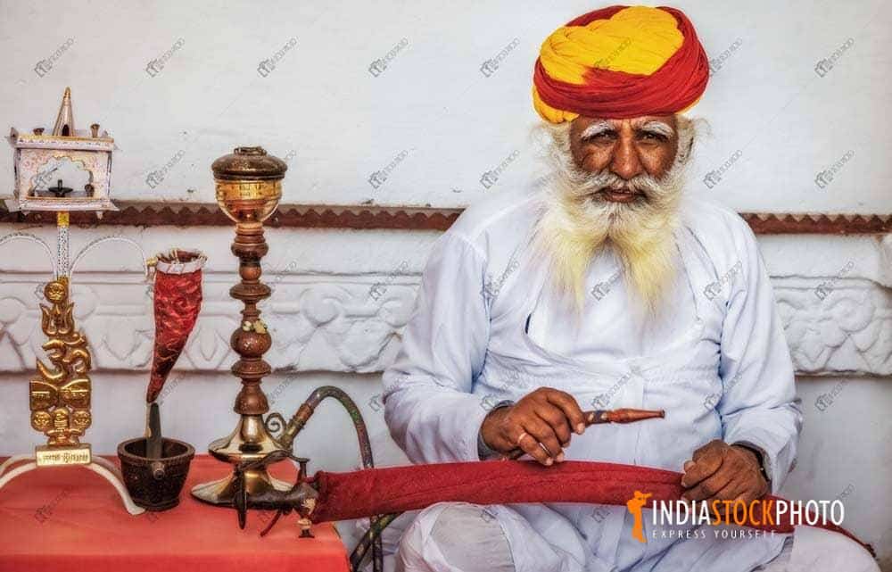 Aged man smoking a pipe at Mehrangarh Fort at Jodhpur