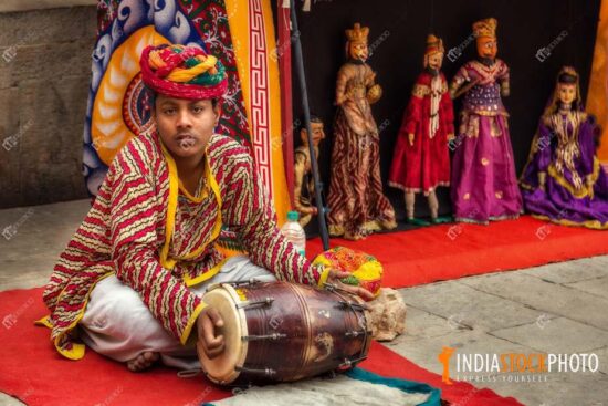 Rajasthan musician plays dholak at puppet show at Jodhpur