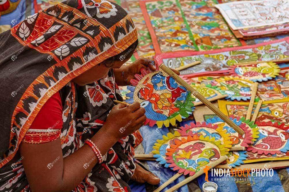 Rural Indian woman making handicraft items for sale