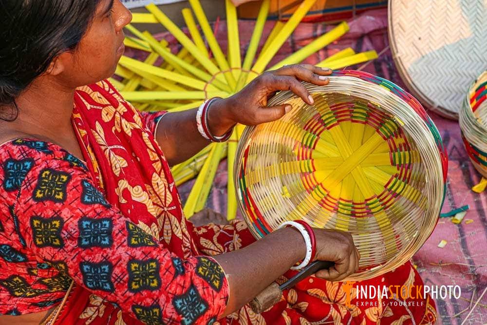 Rural woman weaving a basket