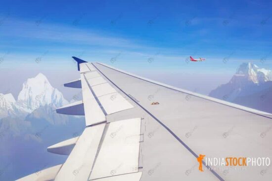 Passenger airplane flies over the Himalayan mountain range