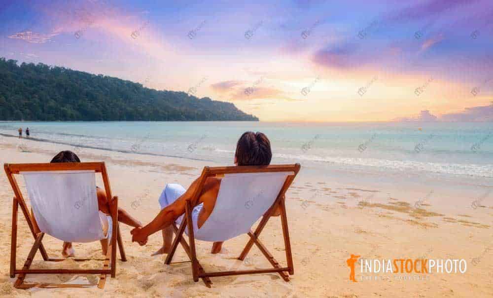 Couple enjoy sunset at Havelock island at Andaman