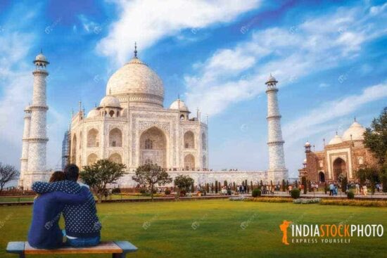 Tourist couple enjoy a romantic moment at the iconic Taj Mahal Agra