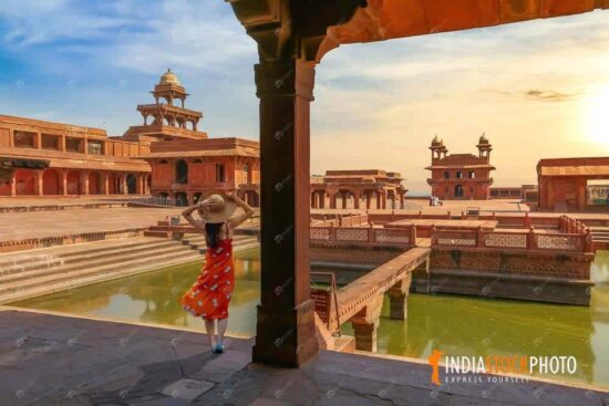 Fatehpur Sikri Agra medieval city at sunset with female tourist enjoying the view