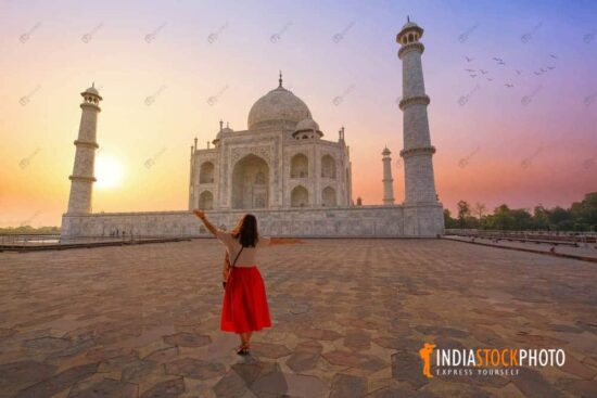 Female tourist enjoy at iconic Taj Mahal Agra at sunrise