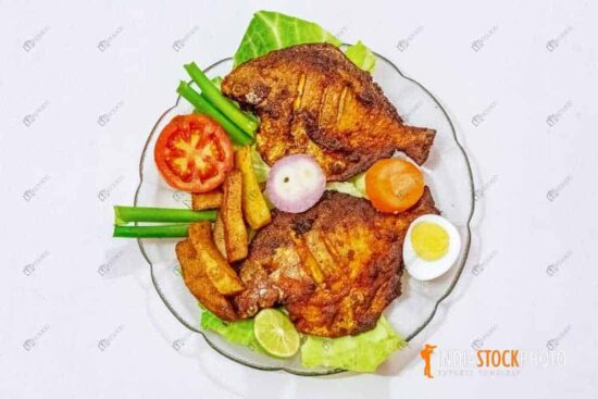 Fried Pomfret fish served with french fries and salad
