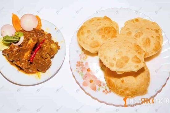 Indian puri with spicy mutton kosha and salad