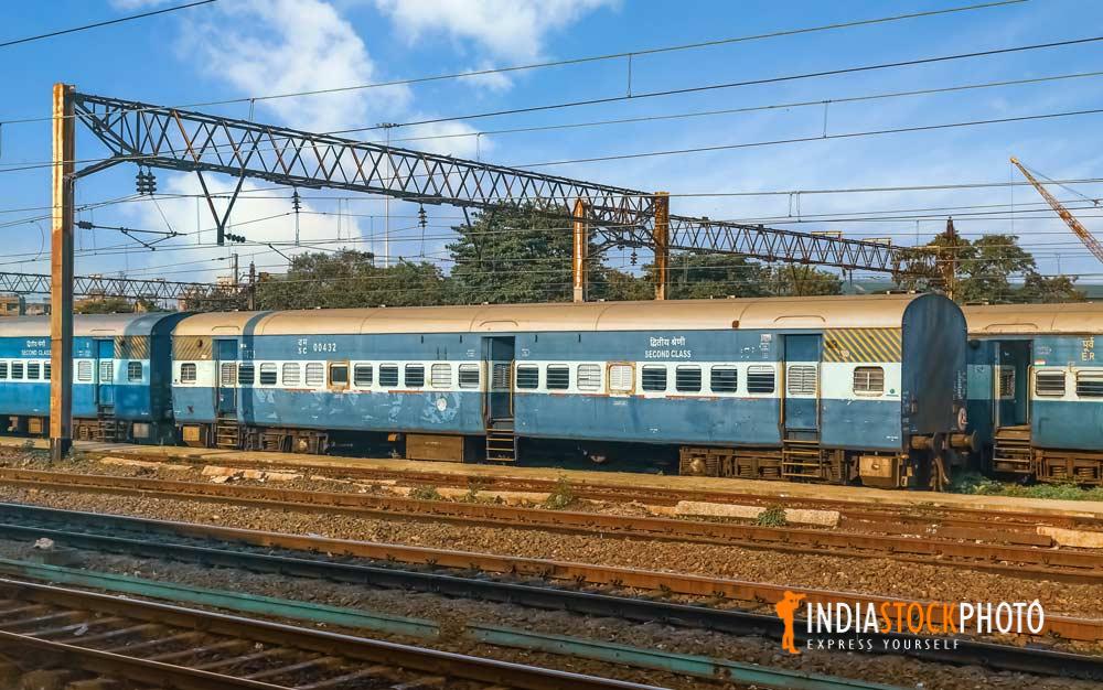 Indian railway coaches standing at a rail yard with view of train tracks