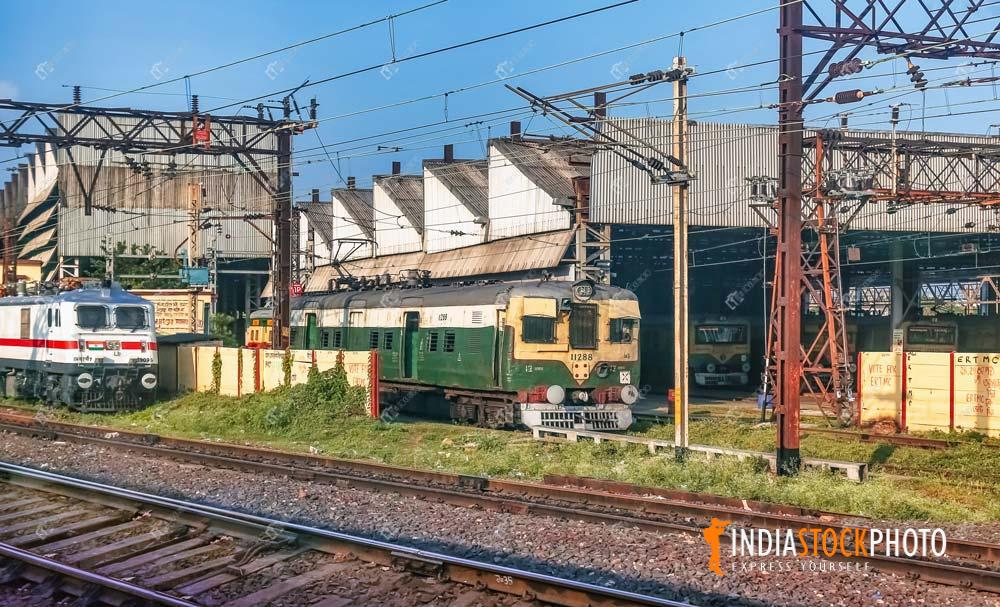 Indian local train and diesel engine near railway loco shed