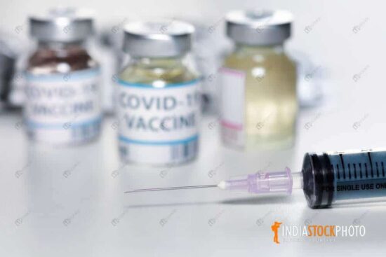Injection needle with coronavirus vaccine bottles