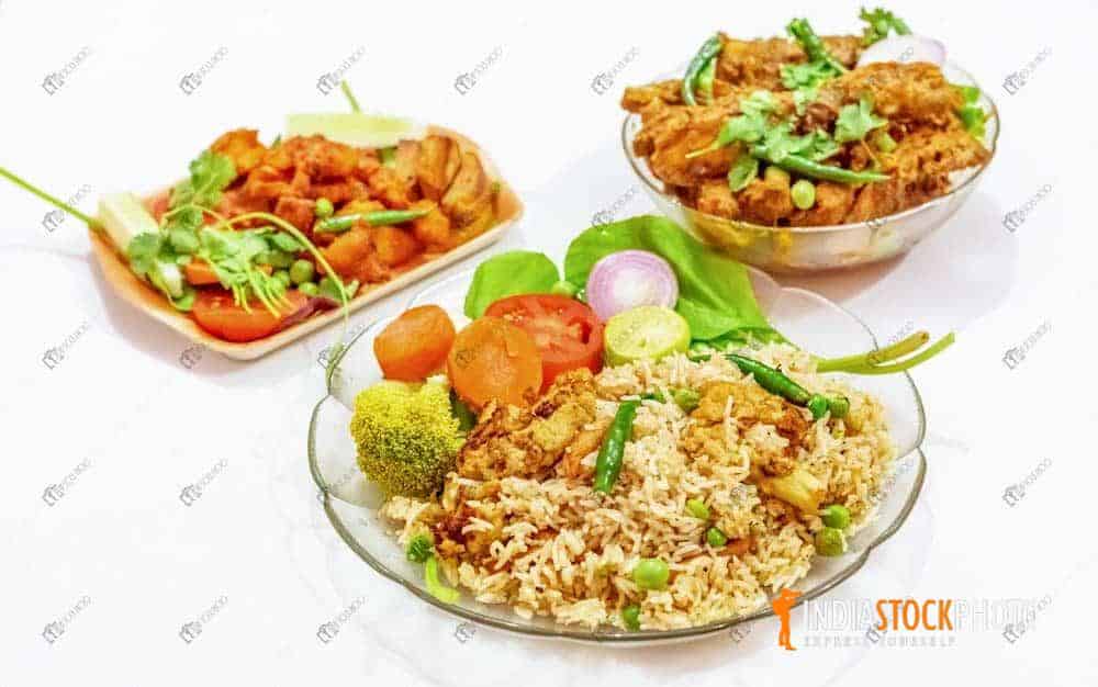 Peas pulao with spicy chicken kosa and fried chicken food dishes