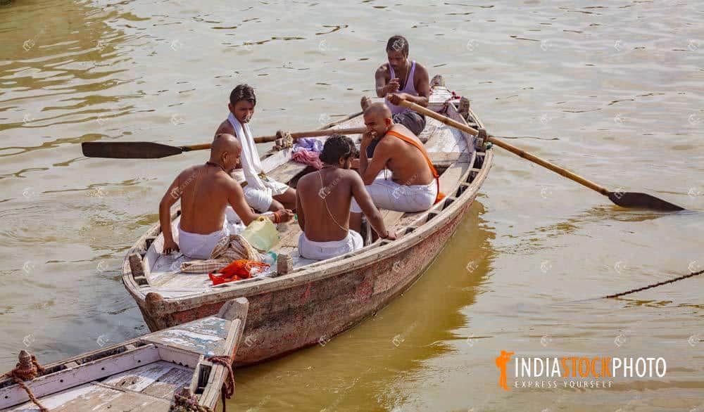 Hindu priests on a boat on river Ganges at Varanasi