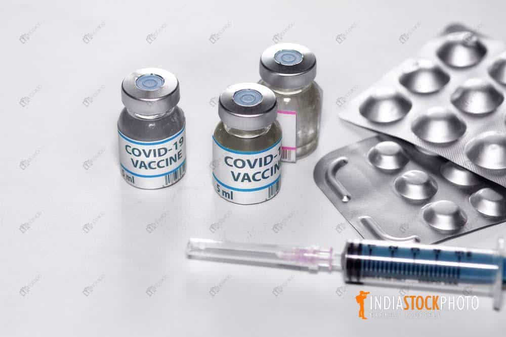 Vaccine bottles with medicinal tablets and injection needle