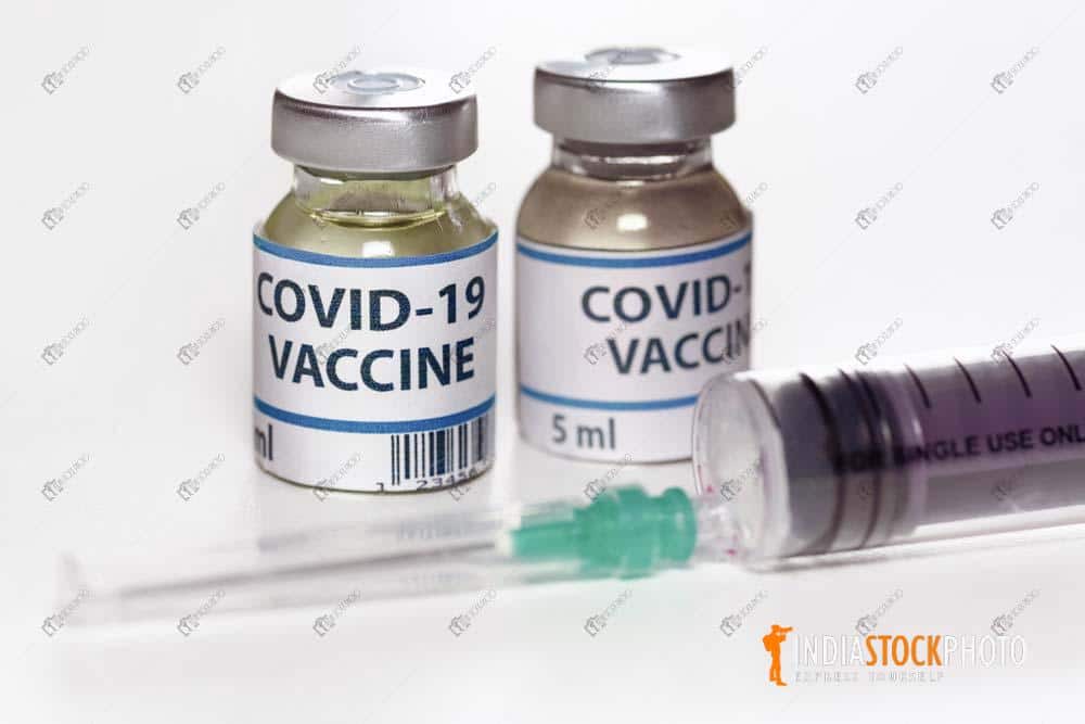 Covid 19 vaccine bottles with injection syringe needle