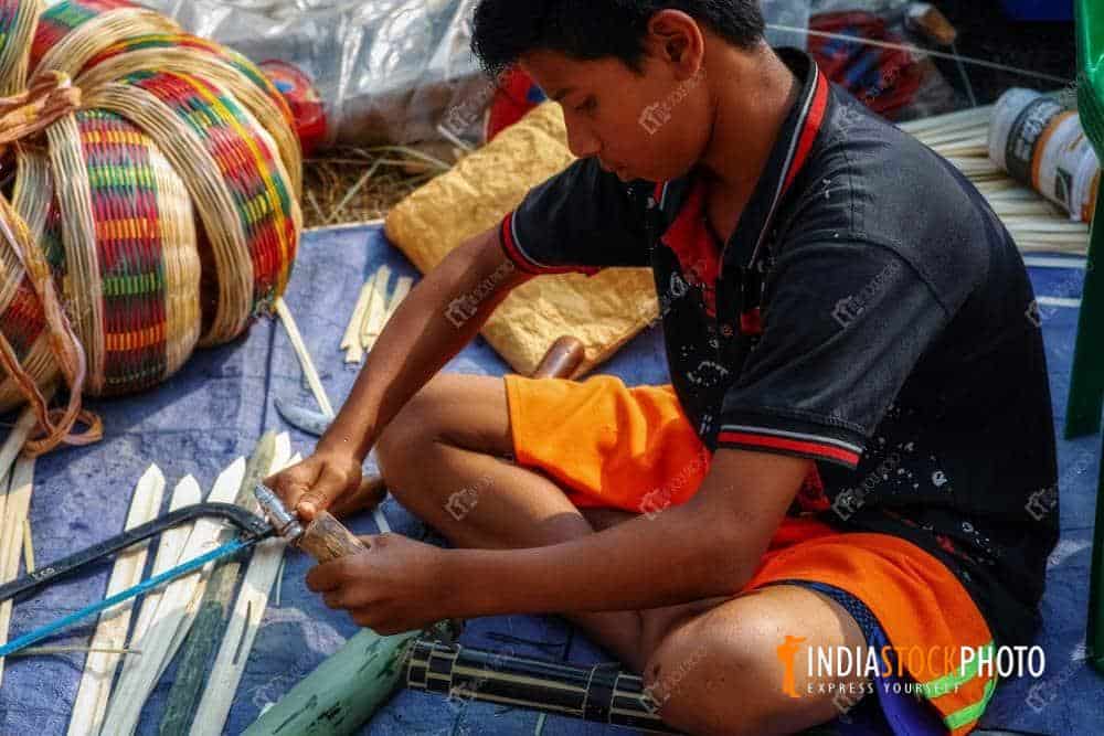 Young rural boy working on a handicraft item at Kolkata fare