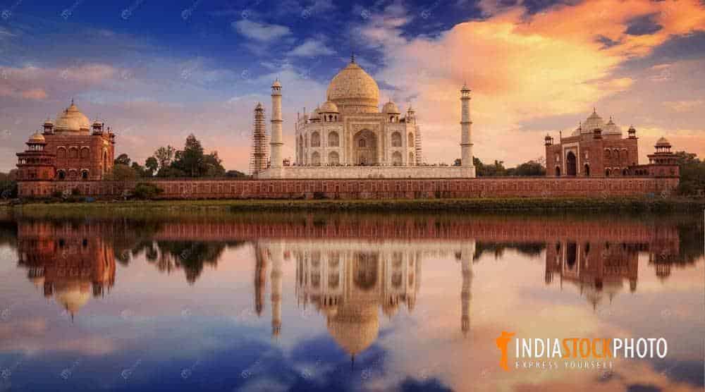 Taj Mahal Agra at sunset with moody sky and water reflection
