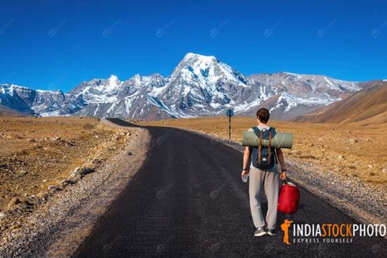 Tourist backpacker on Himalaya mountain road North Sikkim