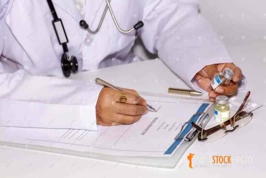 Lady doctor prepares prescription of patient at healthcare clinic