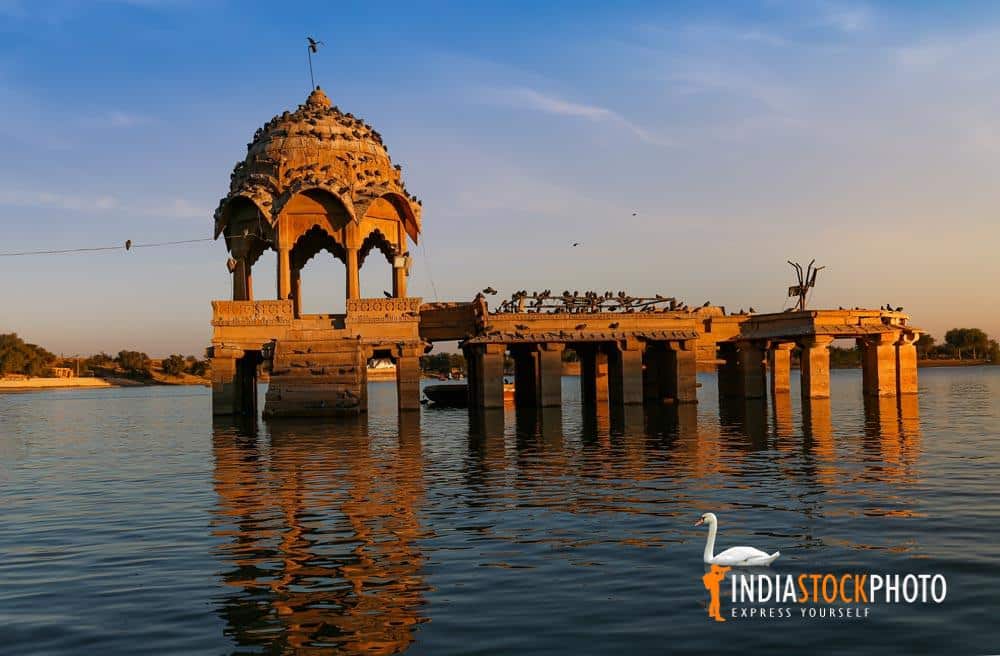 Scenic Gadi Sagar lake at Jaisalmer Rajasthan with ancient architecture at sunset