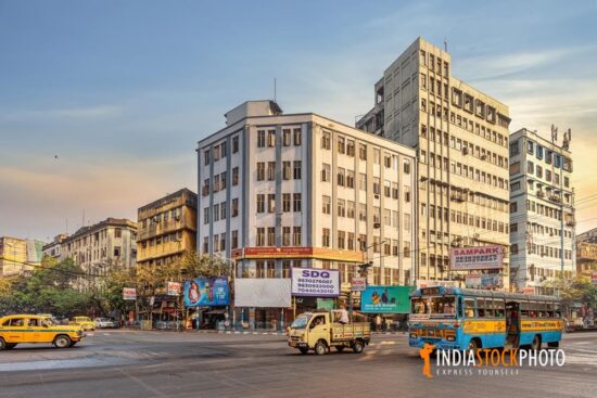 Traffic on city road with view of commercial buildings at Kolkata India